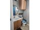 Cozy bathroom featuring round mirror, wooden cabinets, and toilet with Miami Dolphins cover at 4520 Se 28Th St, Ocala, FL 34480