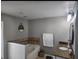 Bathroom featuring granite countertops, a built-in tub, and decorative accents at 4520 Se 28Th St, Ocala, FL 34480