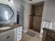 Well-appointed bathroom with granite countertop, tiled shower, and decorative mirror at 4520 Se 28Th St, Ocala, FL 34480