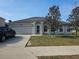 Traditional home with a well-manicured lawn, a two-car garage, and a neatly paved driveway at 4520 Se 28Th St, Ocala, FL 34480