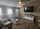 Comfortable living room showcasing neutral tones, wood flooring and a large TV at 4520 Se 28Th St, Ocala, FL 34480
