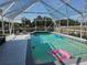 Relaxing screened-in pool area perfect for entertaining, complete with lounge chairs and blue and white tile accents at 4520 Se 28Th St, Ocala, FL 34480