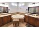 A bathroom with a corner soaking tub flanked by dual vanities at 4990 Sw 63Rd Loop, Ocala, FL 34474
