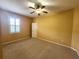 Spacious bedroom featuring carpeted floors, neutral walls, and a ceiling fan with light at 4990 Sw 63Rd Loop, Ocala, FL 34474