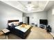 Spacious bedroom with a tray ceiling, carpeted floor, and ample natural light at 4990 Sw 63Rd Loop, Ocala, FL 34474