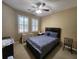 Bedroom with a Queen size bed, ceiling fan and two windows at 4990 Sw 63Rd Loop, Ocala, FL 34474