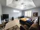 Comfortable bedroom with a tray ceiling, carpeted floor, and a large window at 4990 Sw 63Rd Loop, Ocala, FL 34474