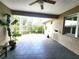 Large covered patio features tile floors, a ceiling fan, and access to the screened porch at 4990 Sw 63Rd Loop, Ocala, FL 34474