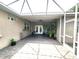 A covered lanai featuring lots of space, tile floors, and a screen door at 4990 Sw 63Rd Loop, Ocala, FL 34474