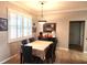 Cozy dining room featuring a traditional table, window with shutters, and neutral-toned walls at 4990 Sw 63Rd Loop, Ocala, FL 34474