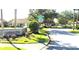 Community entrance featuring a stone sign surrounded by manicured landscaping and gated access at 4990 Sw 63Rd Loop, Ocala, FL 34474