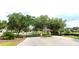 Gated community entrance with stone pillars and lush green trees at 4990 Sw 63Rd Loop, Ocala, FL 34474