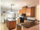 Well-equipped kitchen featuring wood cabinets, black countertops, and a central island at 4990 Sw 63Rd Loop, Ocala, FL 34474