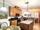 Functional kitchen with wooden cabinetry, black appliances, and an island for extra workspace at 4990 Sw 63Rd Loop, Ocala, FL 34474