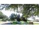 Scenic street view with a white fence bordering the road and lush green trees overhead at 4990 Sw 63Rd Loop, Ocala, FL 34474
