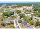 A high definition aerial view of a property in a quiet neighborhood surrounded by trees at 6 Bahia Circle Loop, Ocala, FL 34472