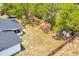 Large, partially fenced backyard featuring mature trees and a shed at 6 Bahia Circle Loop, Ocala, FL 34472