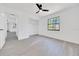 Bright bedroom features new light-grey flooring, ceiling fan, and a large window at 6 Bahia Circle Loop, Ocala, FL 34472