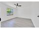 Bright bedroom features new light-grey flooring and a large window at 6 Bahia Circle Loop, Ocala, FL 34472
