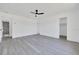 Bright bedroom features new light-grey flooring, ceiling fan, and ensuite bath access at 6 Bahia Circle Loop, Ocala, FL 34472