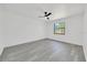 Bright bedroom featuring light grey laminate flooring and a modern ceiling fan at 6 Bahia Circle Loop, Ocala, FL 34472
