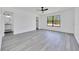 Bright bedroom features new light-grey flooring, ceiling fan, and an ensuite bath at 6 Bahia Circle Loop, Ocala, FL 34472
