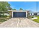 A large two car garage with stone veneer accents and new driveway at 6 Bahia Circle Loop, Ocala, FL 34472