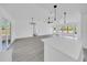 Open-concept kitchen and living room with eat-in island and modern hanging lights at 6 Bahia Circle Loop, Ocala, FL 34472