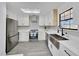 Bright kitchen with stainless steel appliances, white cabinets, and skylight at 6 Bahia Circle Loop, Ocala, FL 34472