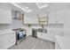 Bright kitchen with stainless steel appliances, white cabinets, and skylight at 6 Bahia Circle Loop, Ocala, FL 34472