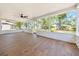 Enclosed screened porch with natural light, tiled flooring, and ceiling fan at 6 Bahia Circle Loop, Ocala, FL 34472