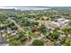 Aerial view of a home surrounded by mature trees and located near the water at 705 Washington Ave, Eustis, FL 32726