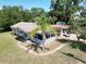 Aerial view of a home showcasing a welcoming screened-in porch, carport, and lovely landscaping at 705 Washington Ave, Eustis, FL 32726