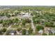 Aerial view of the home surrounded by mature trees in a friendly neighborhood setting at 705 Washington Ave, Eustis, FL 32726