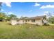 Expansive backyard featuring lush greenery and a partially fenced area at 705 Washington Ave, Eustis, FL 32726