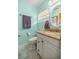 Bathroom with tile flooring and a granite topped vanity with stainless steel fixtures at 705 Washington Ave, Eustis, FL 32726