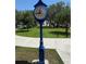 Outdoor clock in park setting with trees and green lawn at 705 Washington Ave, Eustis, FL 32726