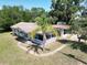 Charming single-story home with a screened porch and a mature palm tree in the front yard at 705 Washington Ave, Eustis, FL 32726