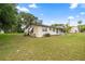 Charming single-story home with a lush green yard, mature trees and inviting curb appeal at 705 Washington Ave, Eustis, FL 32726