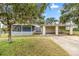 Lovely single-Gathering home showcasing a screened porch and convenient carport at 705 Washington Ave, Eustis, FL 32726