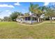 Inviting single-Gathering home featuring a screened porch, mature trees, and a carport at 705 Washington Ave, Eustis, FL 32726