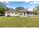Charming single-story home with a screened-in porch and well-maintained lawn at 705 Washington Ave, Eustis, FL 32726