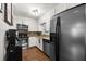 Kitchen features stainless steel appliances, white cabinets, granite countertops, and wood flooring at 705 Washington Ave, Eustis, FL 32726