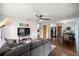 Open living room boasts hardwood floors, ceiling fan, and comfortable seating with a view to dining area at 705 Washington Ave, Eustis, FL 32726