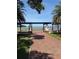 Scenic view of lake framed by a pergola in a park setting at 705 Washington Ave, Eustis, FL 32726