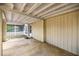 Covered patio area with a concrete floor and exposed beams, providing ample space for outdoor enjoyment at 705 Washington Ave, Eustis, FL 32726