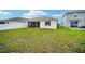 Expansive backyard featuring healthy green grass and a screened-in porch with outdoor furniture at 7224 Sw 61St Pl, Ocala, FL 34474
