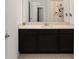 Modern bathroom vanity with dark wood cabinets and neutral countertops at 7224 Sw 61St Pl, Ocala, FL 34474