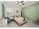 Cozy bedroom featuring a pink bed frame, ceiling fan, and light-filled window at 7224 Sw 61St Pl, Ocala, FL 34474