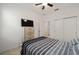 Cozy bedroom with tile floors, a large window, a TV, and neutral wall color at 7224 Sw 61St Pl, Ocala, FL 34474